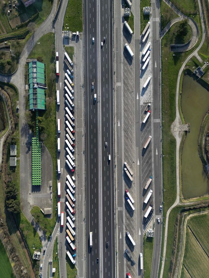 The Art of Drawing Readers In: Your attractive post title goes here Highway traffic captured from above showcasing trucks and parked vehicles in Roncade, Italy.