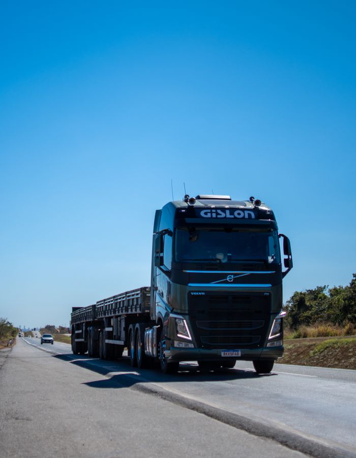 Crafting Captivating Headlines: Your awesome post title goes here A black truck travels on a sunny highway in Brazil under clear blue skies.